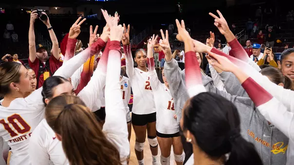 USC Trojans volleyball team huddling with victory signs raised after a 2026 season match in Los Angeles