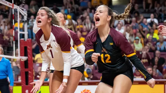 Golden Gophers volleyball players reacting emotionally after a big rally win at Maturi Pavilion