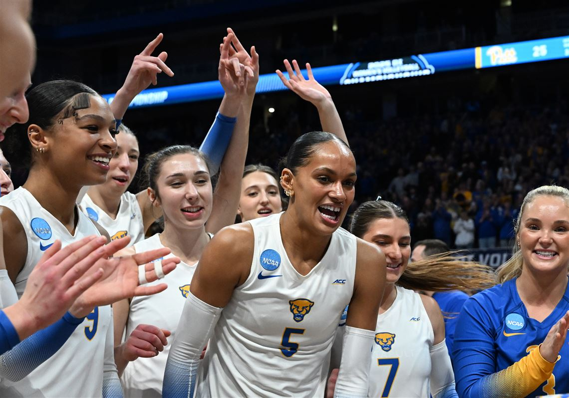 Pittsburgh volleyball team celebrating an NCAA Tournament win in front of a packed crowd