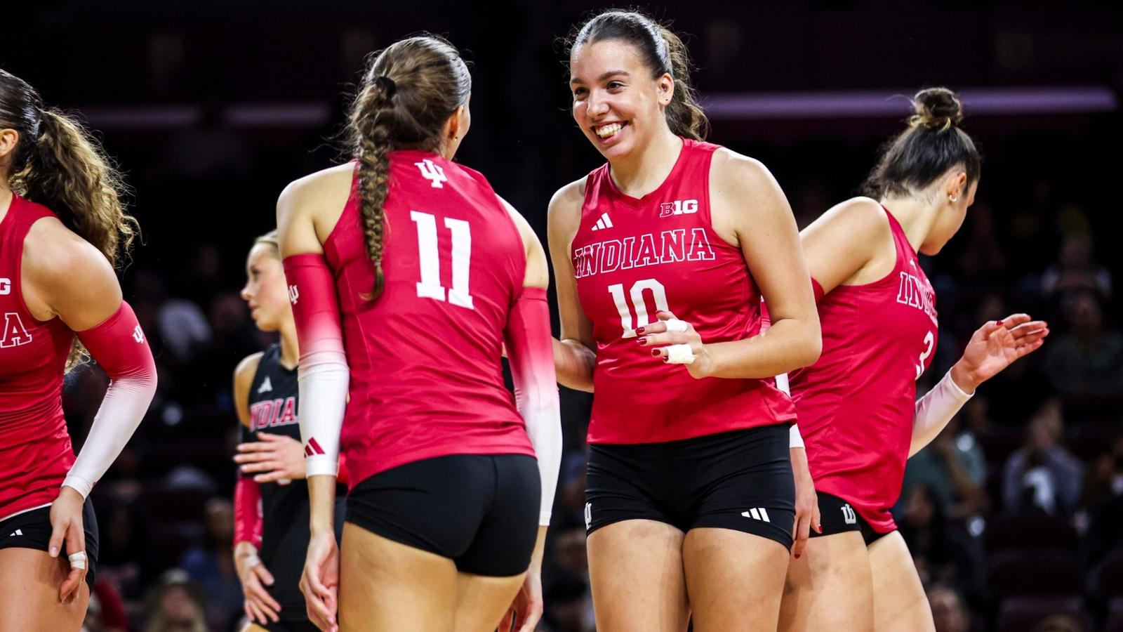 Indiana Hoosiers volleyball teammates smiling between points during a 2026 schedule match