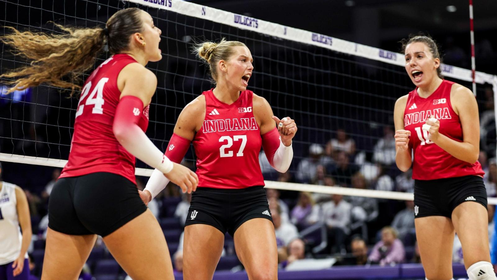 Indiana volleyball player number 27 fired up with teammates at the net during a 2026 Big Ten match