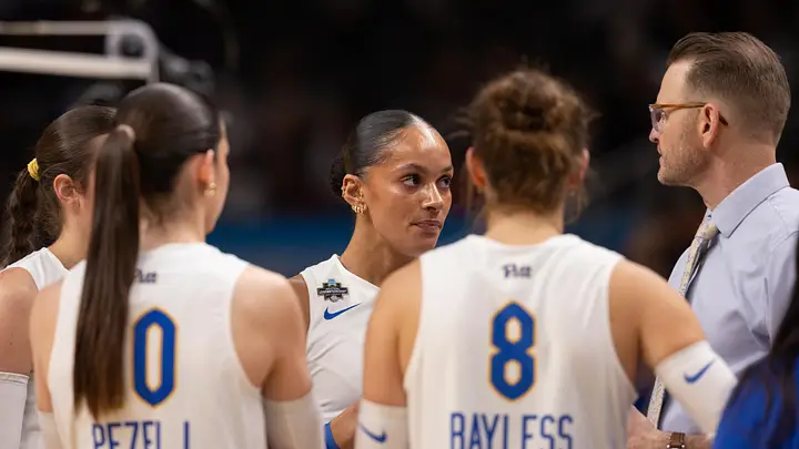 Pitt volleyball coaches huddling with players during an NCAA Final Four timeout