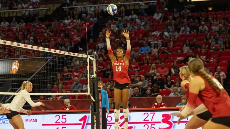 Miami volleyball player number 14 setting the ball at the net during a 2026 season home match