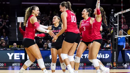 Indiana Hoosiers volleyball players celebrating a point together during a 2026 season road match