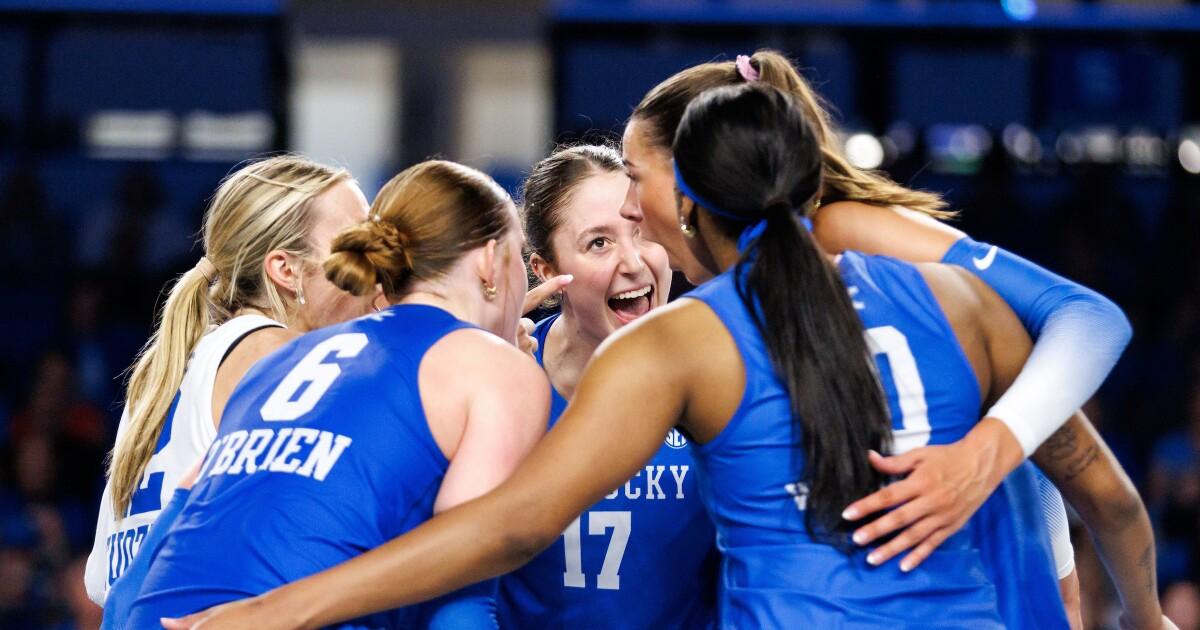 Kentucky volleyball teammates huddling and celebrating at the net during a 2026 match