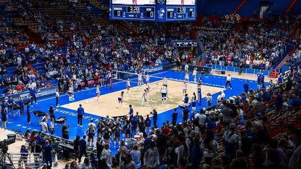 Kansas Jayhawks volleyball warming up before a home match with a full crowd in the stands during the 2026 season
