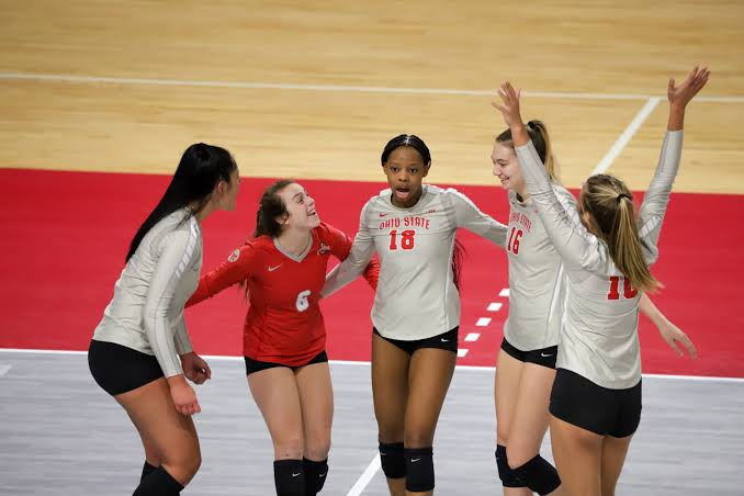 Ohio State volleyball players celebrating a point together on the court during a 2026 season match