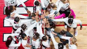 Overhead view of the UNLV Lady Rebels volleyball team huddling at center court at Cox Pavilion during the 2026 season