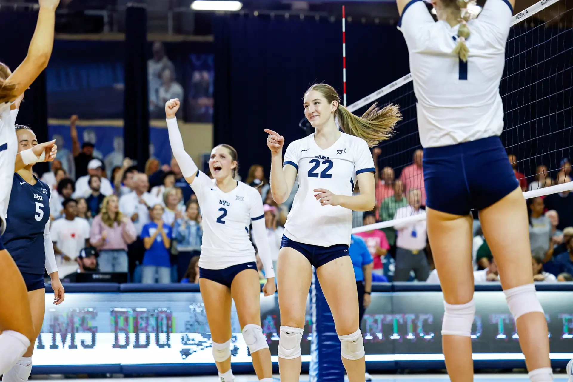 BYU Cougars volleyball players celebrating in front of a packed home crowd during the 2026 season