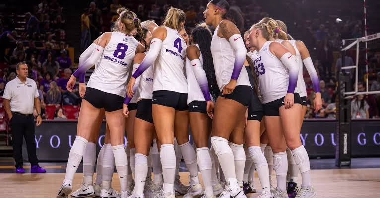 TCU volleyball team huddling with their head coach during a Big 12 road match on the 2026 schedule