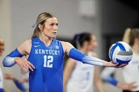 Kentucky Wildcats volleyball player wearing the blue No. 12 jersey holding a volleyball before a match