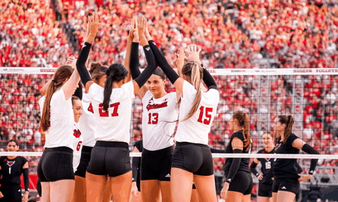 Nebraska volleyball team huddles at the net before a 2026 match