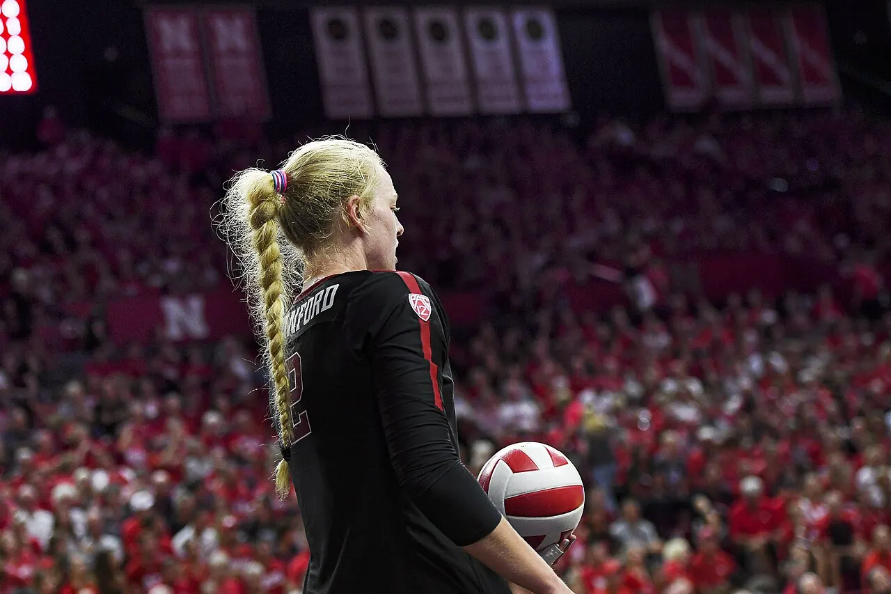 Stanford player Kathryn Plummer holding a volleyball before serving against Nebraska.