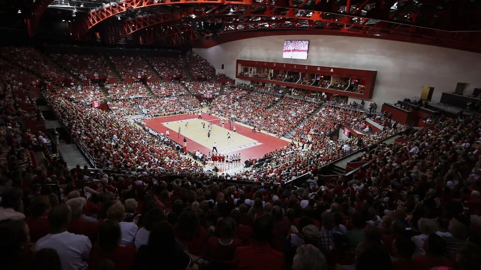 A large crowd surrounding the red volleyball court inside Nebraska’s Devaney Sports Center